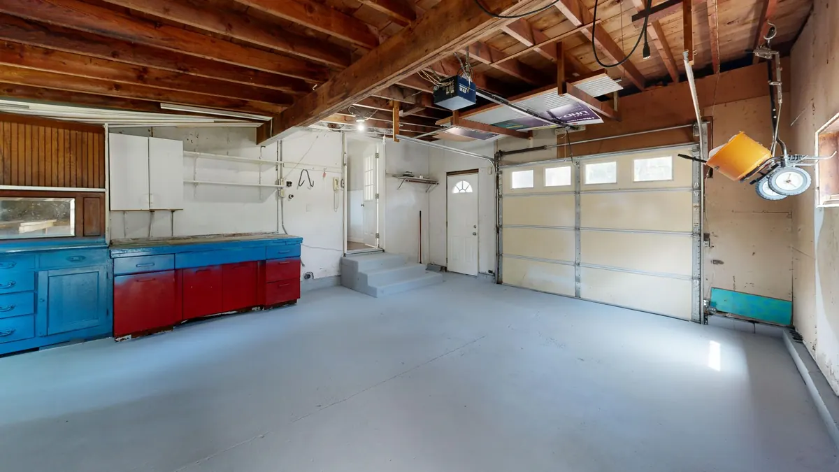 Garage with a gray coated floor and cabinets