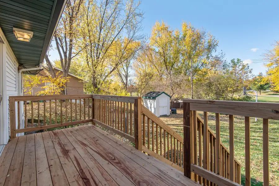 Stained wooden deck with railings and stairs