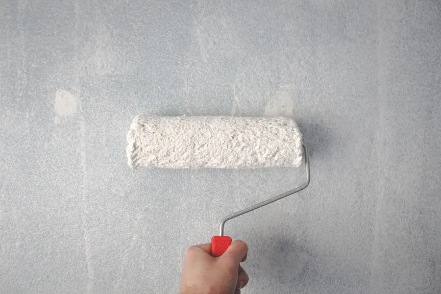 Paint roller on a wall