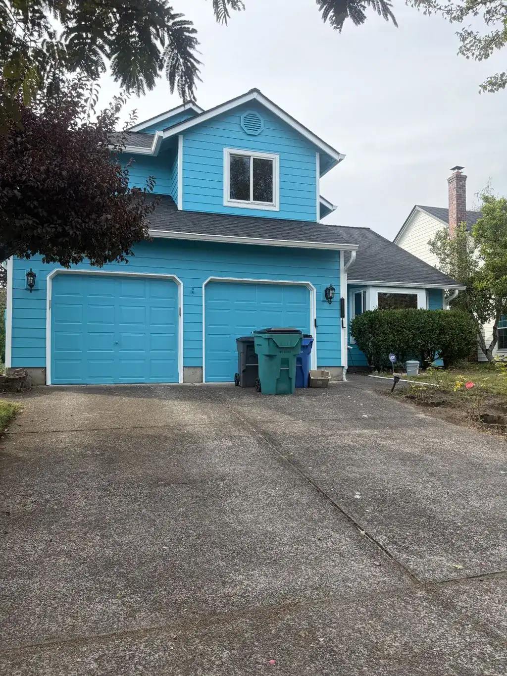 Blue house with a double garage after exterior painting